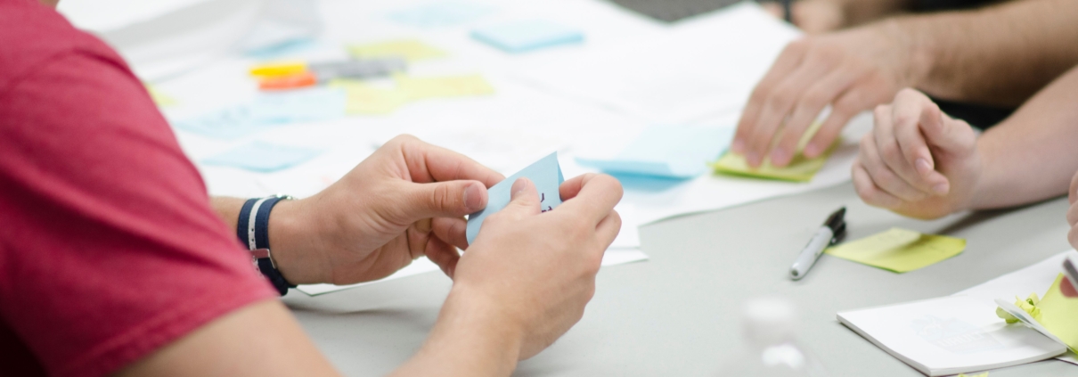 People At Desk With Sticky Notes